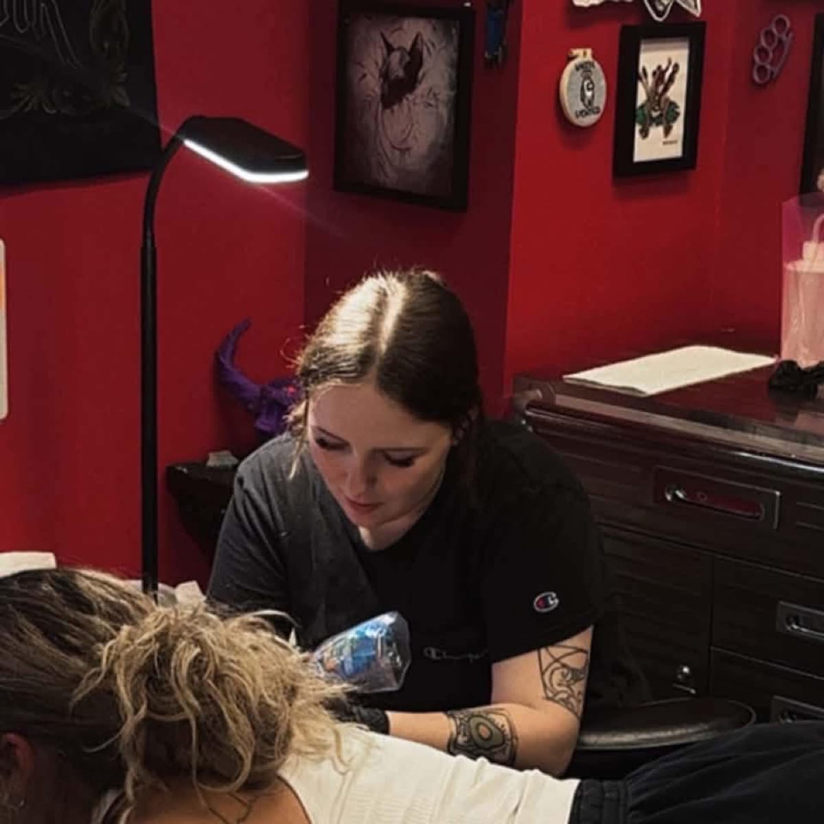 Jess Fuller, resident artist at Fodor Ink, tattooing a client